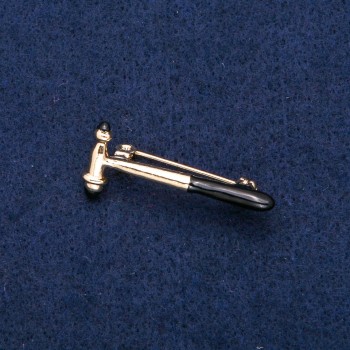 Broche «Martillo neurológico», esmalte negro y metal dorado 16×36 mm